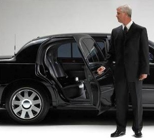 Chauffeur standing with door open